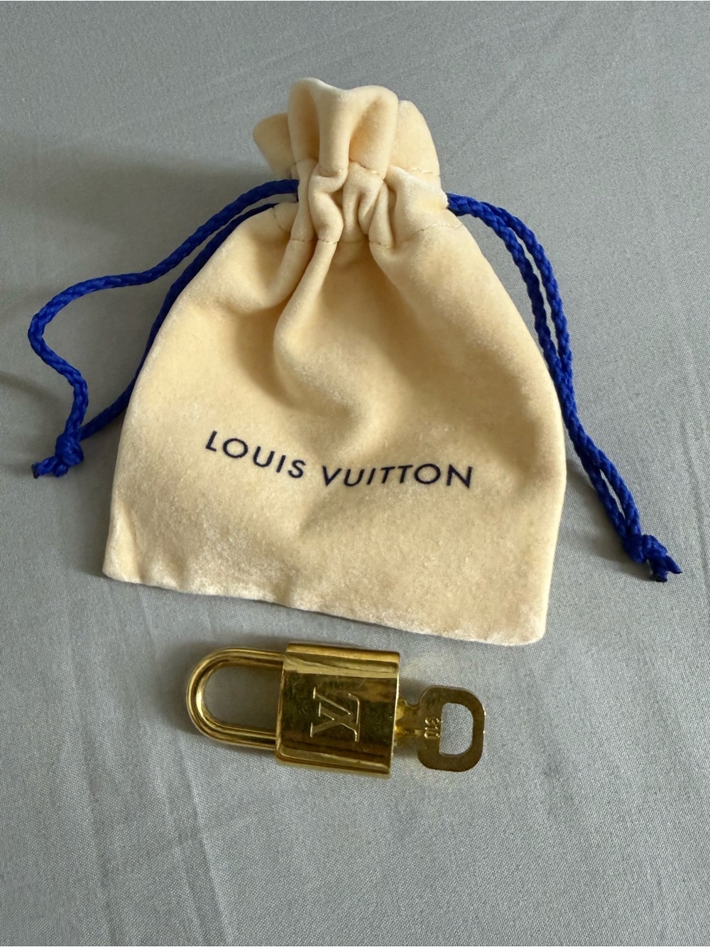 Louis Vuitton Gold Padlock with Cream Dust Pouch and Blue Drawstrings